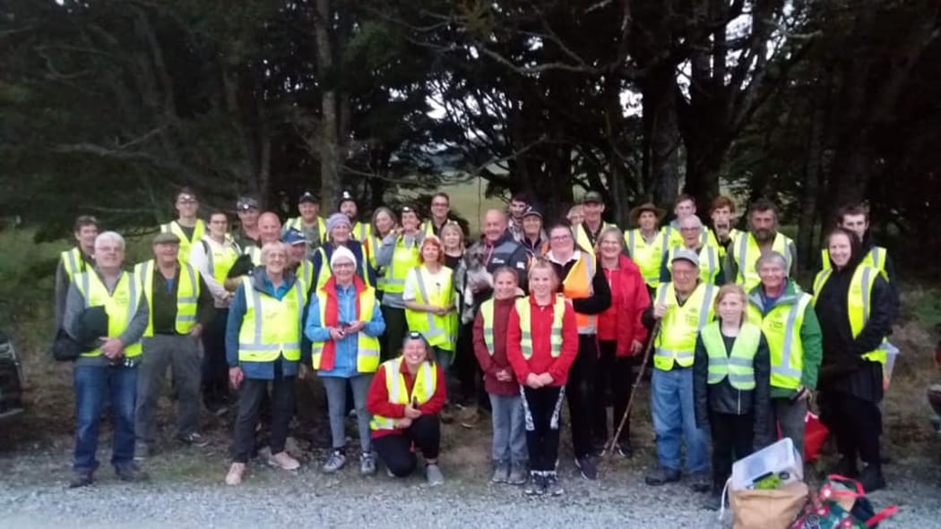A group of volunteers in high vis vests take part in a survey for bats as part of the Catlins Bats on the Map project.