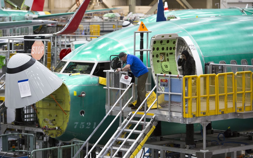 (FILES) In this file photo taken on March 27, 2019 Employees work on Boeing 737 MAX airplanes at the Boeing Renton Factory in Renton, Washington.