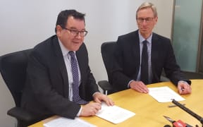 Finance Minister Grant Robertson re-signing the current Policy Targets Agreement with Reserve Bank Acting Governor Grant Spencer.