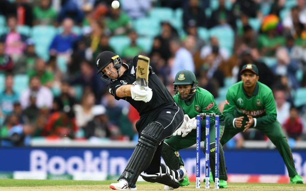 Martin Guptill hits a six.