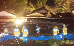 An elderly woman is rescued by firefighters and police officers in Suzu, Ishikawa Prefecture on 6 January, 2024, five days after the massive earthquake occurred.