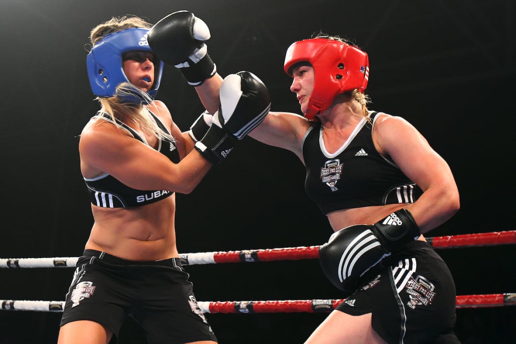 Snowboarder Hayley Holt takes on surfer Paige Hareb in a Fight For Life charity boxing event.