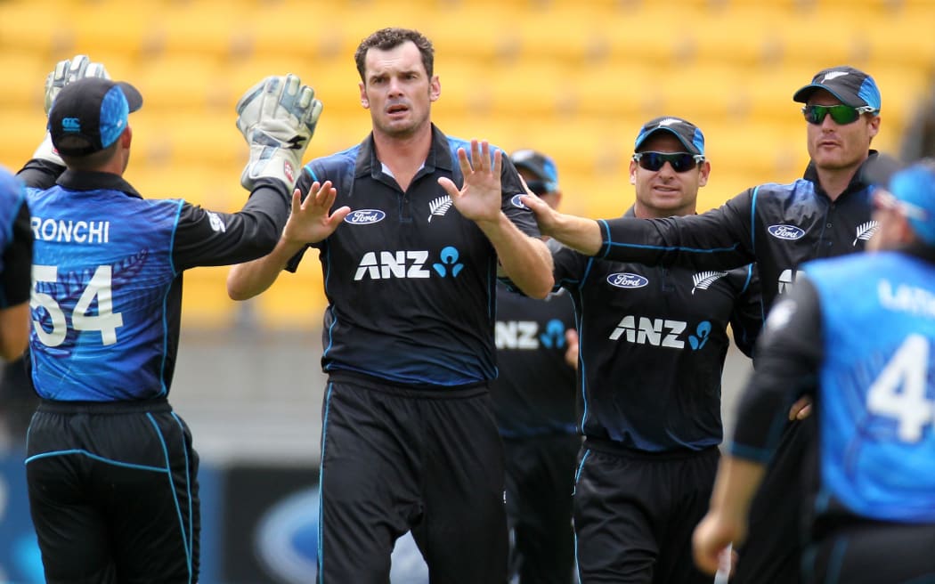 Kyle Mills is congratulated after bowling Mohammad Hafeez in the first over