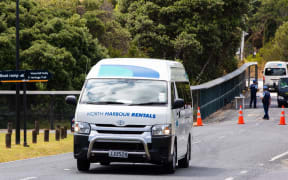 The first evacuees leave quarantine at the Whangaparāoa military base.