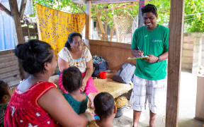 Child Fund NZ staff in Kiribati visit a family in Betio, Tarawa.