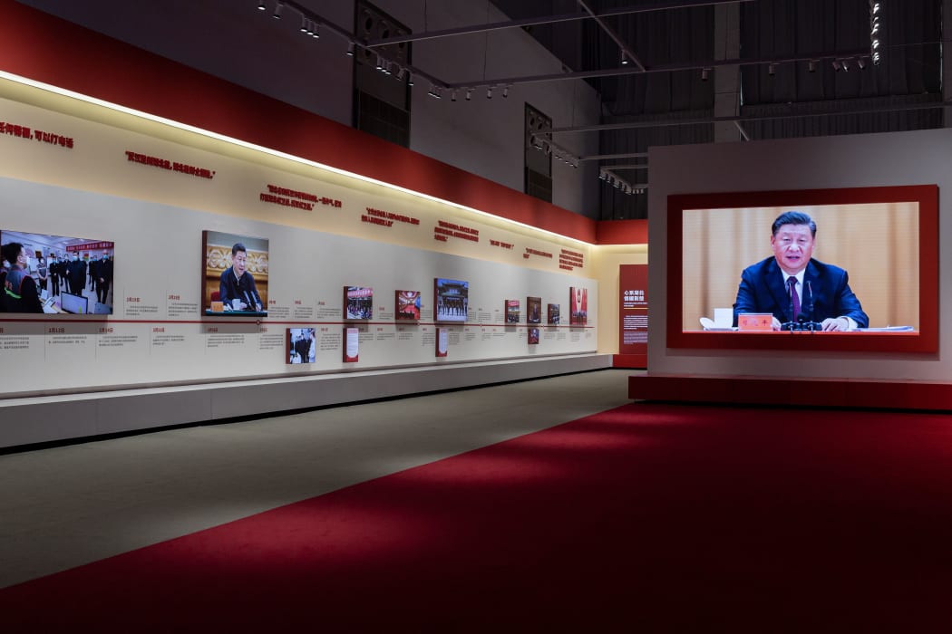 A video of China's President Xi Jinping plays on a large screen at an exhibition about Chinas fight against Covid-19. 15 January, 2021.