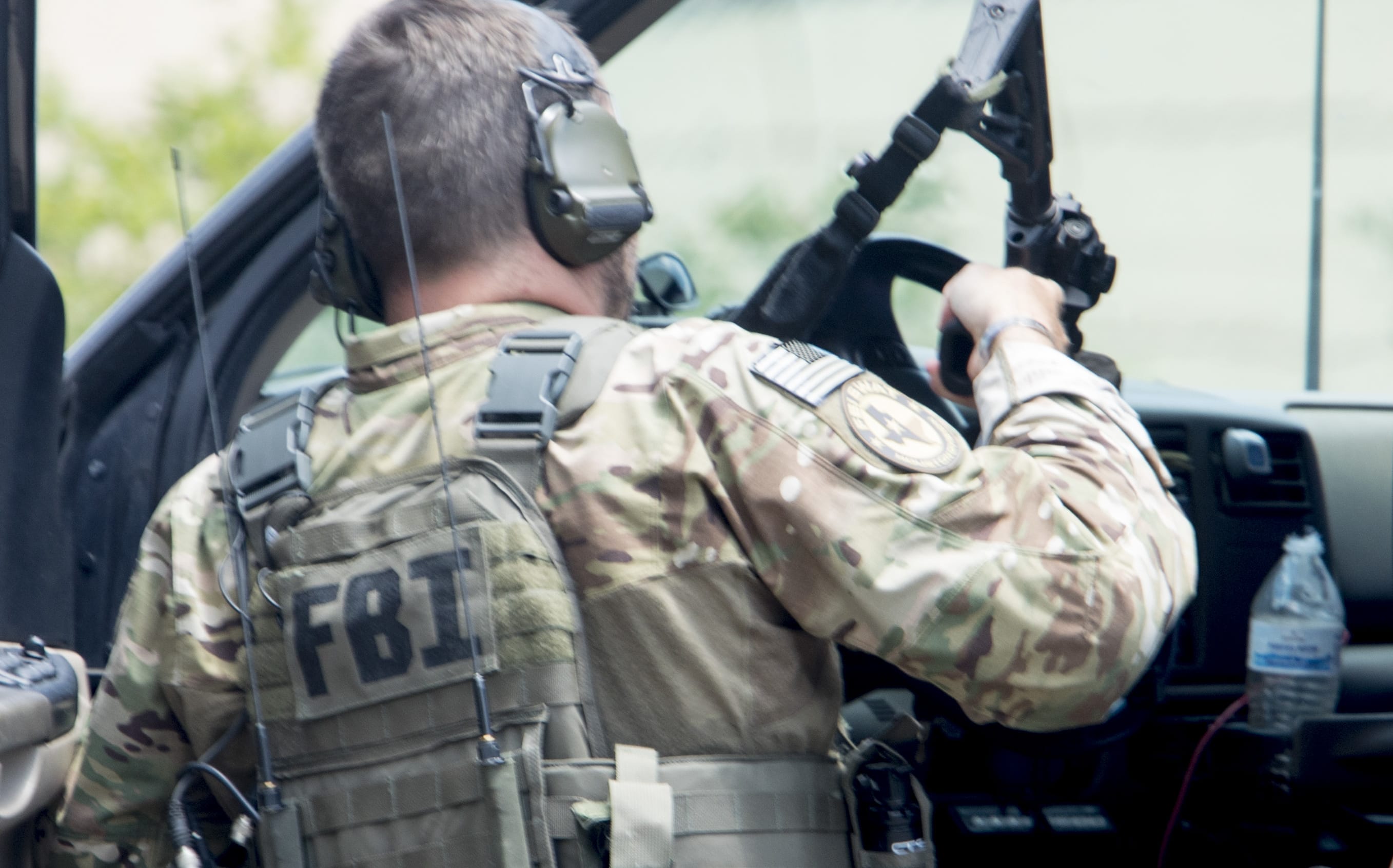 An FBI agent is seen in the parking lot of Santa Fe High School where at least eight people were killed on 18 May, 2018.