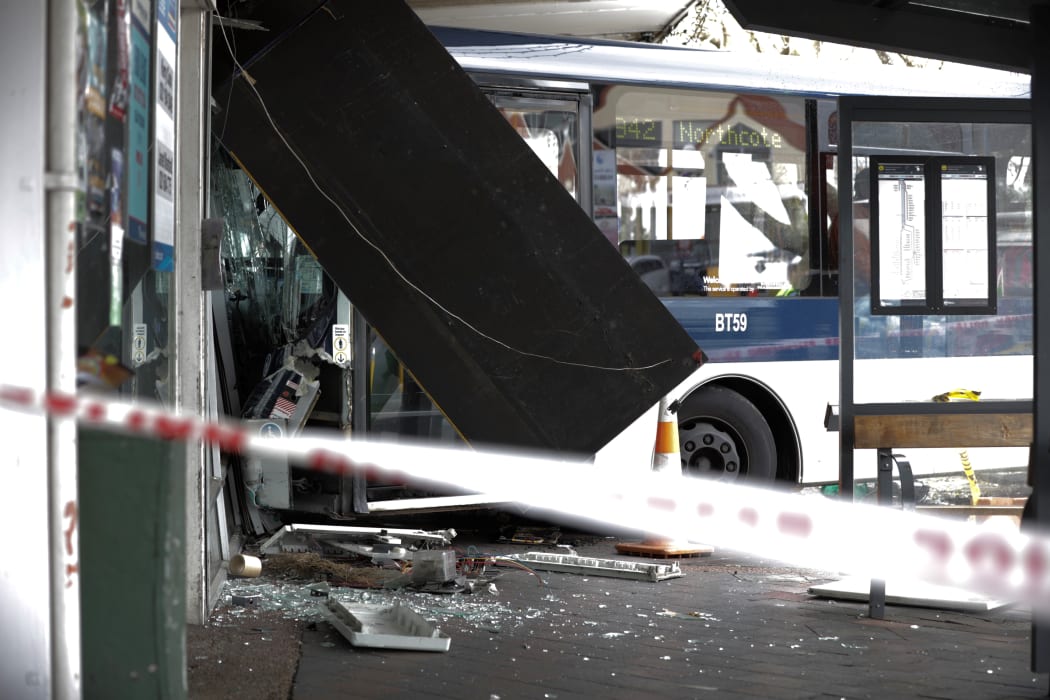 The bus was left sticking out of the shop.