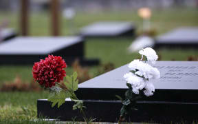 Flowers are seen on the graves of the Christchurch's terror attack victims at the Memorial Park Cemetery on the first day of the four-day of Australian white supremacist Brenton Tarrant's sentencing hearing in Christchurch on August 24, 2020.