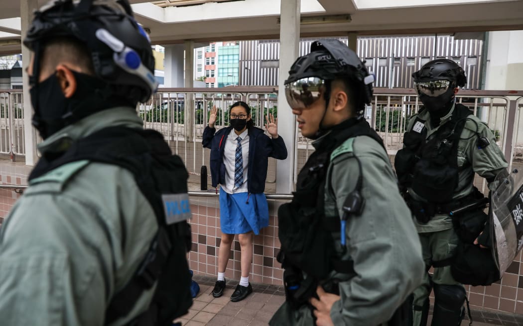 A school student is questioned by police in the Sai Wan Ho district in Hong Kong on November 12, 2019 following a day of pro-democracy protests.