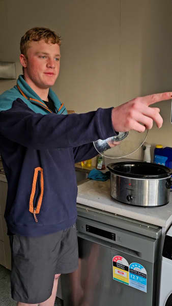 Jake Corney with his Himalayan tahr stew in the crockpot.