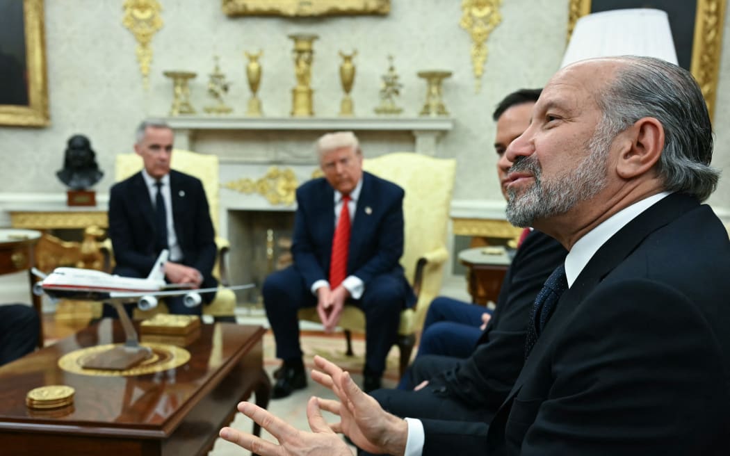 US Secretary of Commerce Howard Lutnick speaks as US President Donald Trump and Canadian Prime Minister Mark Carney look on in the Oval Office of the White House in Washington, DC, on May 6, 2025. (Photo by Jim WATSON / AFP)
