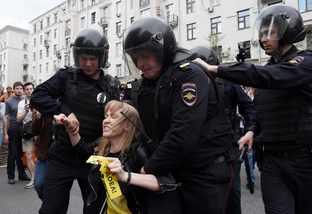 Russian police officers detain Maria Baronova, a coordinator of Khodorkovsky's Open Russia organization as she participates at the unauthorized opposition rally in Tverskaya street in central Moscow on June 12, 2017.