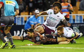 Shaun Johnson injures his ankle as he scores against Manly