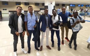 Manus Island refugees waiting to leave Port Moresby's airport, including from left, Mohamed Sanosi and Omar Muhammed Jack.
