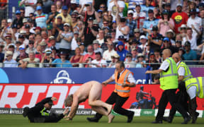 A streaker disrupts play during the Cricket World Cup fixture between England and New Zealand.