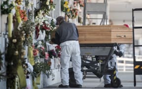 Gravediggers at work during a burial in a niche in Turin 
During the lockdown due to the Covid 19 epidemic, the number of funerals increased dramatically.