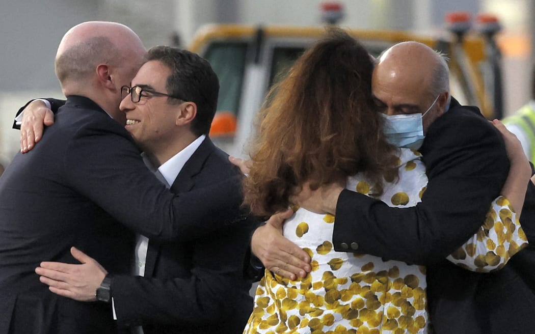 US citizens Siamak Namazi, second left, and Morad Tahbaz, right, are welcomed upon disembarking from a Qatari jet on their arrival at Doha International Airport, Doha, 18 September, 2023.
