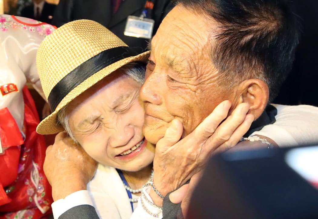 South Korean Lee Keum-seom (L), 92, meets with her North Korean son Ri Sung Chol (R), 71, during a separated family reunion meeting at the Mount Kumgang resort on the North's southeastern coast on August 20, 2018.
