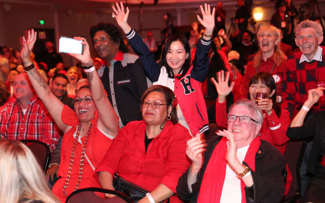 Labour party supporters react as they await Labour Leader Jacinda Ardern to arrive as they watch the results come for New Zealand's general election in Auckland on October 16, 2020.
