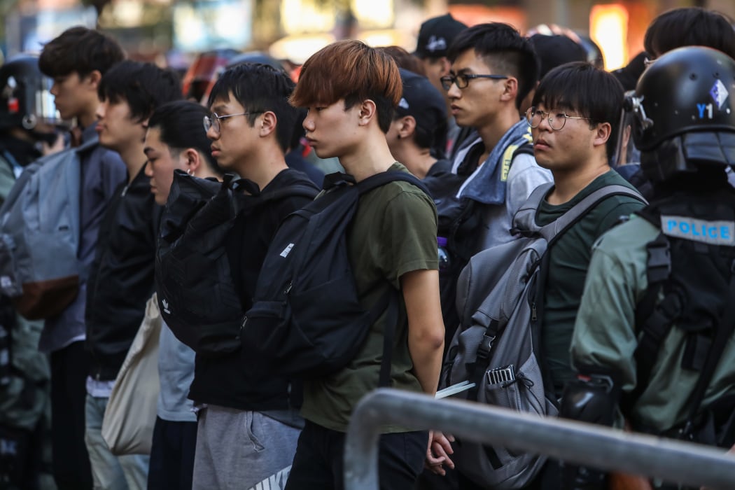 People are detained by police near the Hong Kong Polytechnic University in Hung Hom district of Hong Kong on November 18, 2019. -