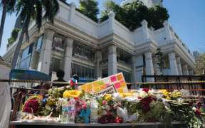 Flowers are laid at the entrance to the reopened Erawan Shrine in Bangkok.