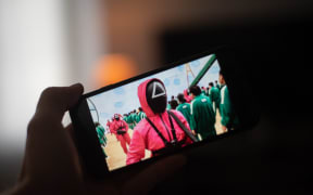 France, Excideuil, 2021-10-06. Watch the Netflix Squid Game series on a mobile phone. Photograph by Romain LONGIERAS / Hans Lucas. France, Excideuil, 2021-10-06. Visionnage de la serie Squid Game de Netflix sur un telephone portable. Photographie de Romain LONGIERAS / Hans Lucas. (Photo by Romain Longieras / Hans Lucas / Hans Lucas via AFP)