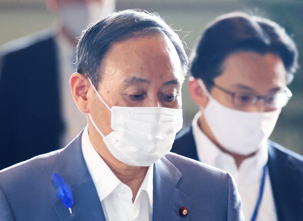 Japan's Prime Minister Yoshihide Suga wearing a face mask amid continuing worries over Covid-19 in July.