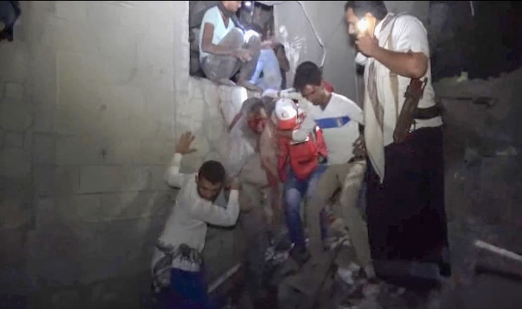 Yemenis rescuing a man from a site following Saudi-led airstrikes on Yemen's rebel-held port city of Hodeidah.