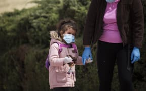 26.04.2020 A girl and her mother walk in a park in Madrid, Spain after children under the age of 14 were allowed to go for a walk for one hour, between 9am to 9pm, after more than 40 days of Covid-19 quarantine in the country.