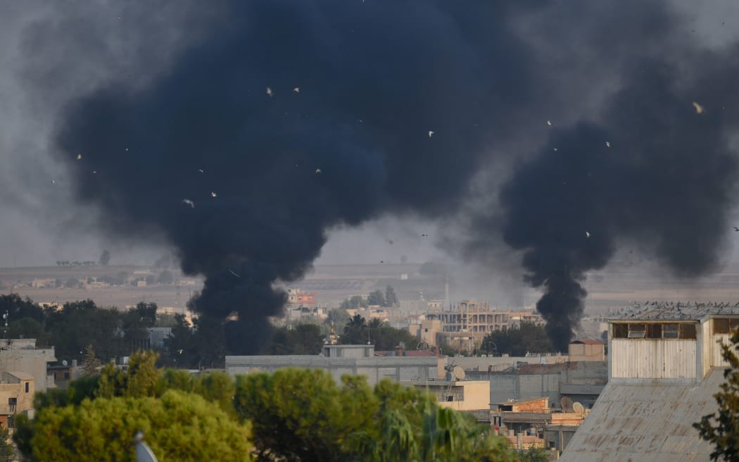 Turkey's Sanliurfa province, on October 09, 2019. Smoke rises at the site of Ras al-Ayn city of Syria