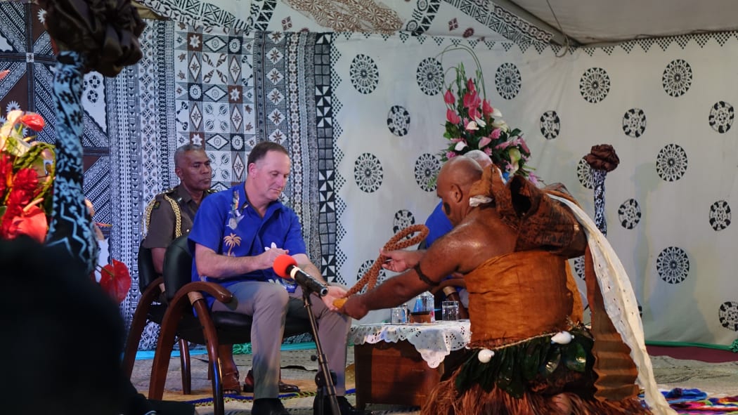 John Key receiving kava root.