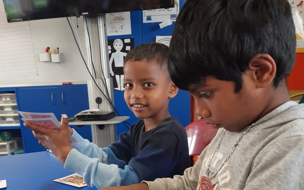 Children learn maths through card games and puzzles.