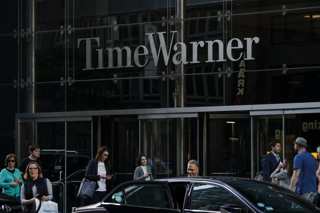 People walk past the Time Warner Center, June 12, 2018 in New York City. A federal judge today said that AT&T can move forward with its $85 billion acquisition of Time Warner, which the U.S. Justice Department had sought to block.