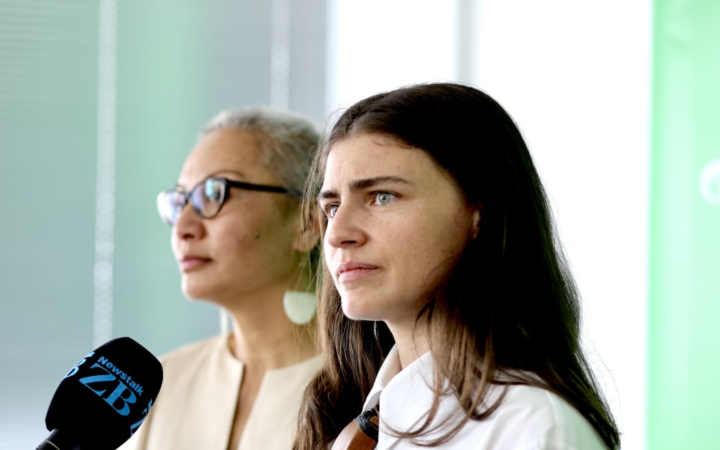 Chloe Swarbrick with Marama Davidson in background