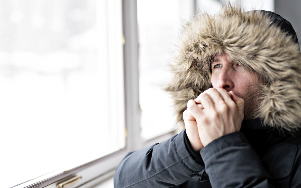 A Man With Warm Clothing Feeling The Cold Inside House