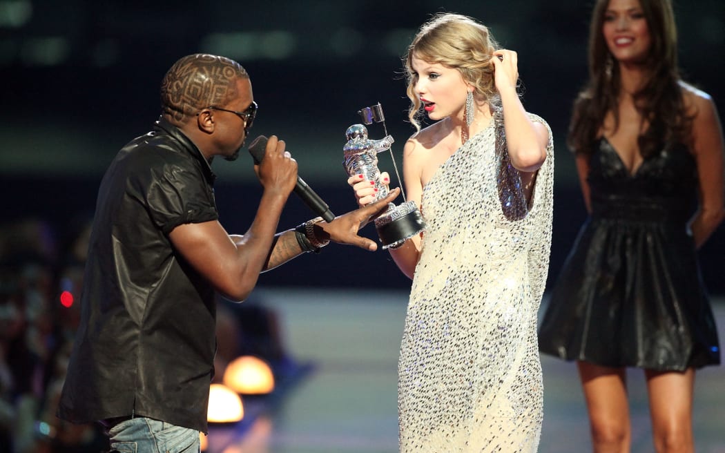 Kayne West (left) jumps onstage after Taylor Swift won the "Best Female Video" award during the MTV Video Music Awards at Radio City Music Hall on 13 September, 2009 in New York City.