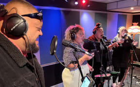 Rakai Whauwhatu performing live in the RNZ studio with three backing singers.