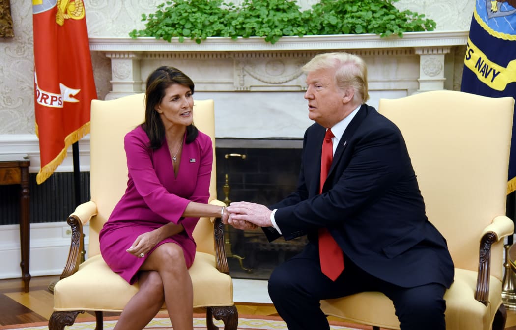 US President Donald Trump shakes hands with Nikki Haley, the United States Ambassador to the United Nations in the Oval office.