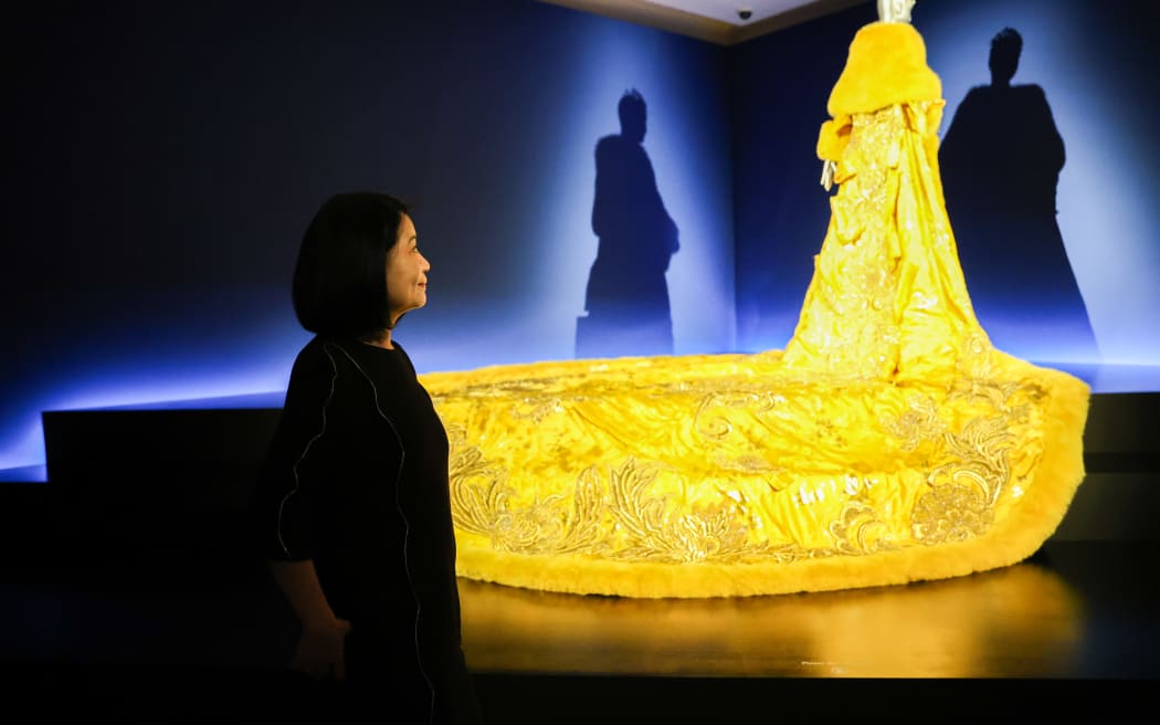Chinese artist Guo Pei with The Yellow Queen - part of the exhibition Guo Pei: Fashion, Art, Fantasy, which was shown at the Auckland Art Gallery in 2023.