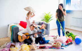 Mother is cleaning mess after her daughters played