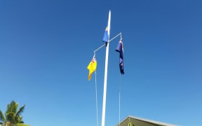 Niue and New Zea land flags raised outside the fono.