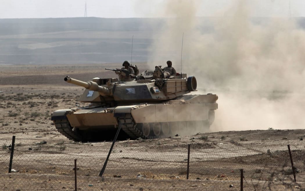 Iraqi government forces enter the village of al-Khuwayn, south of Mosul, after recapturing it from Islamic State (IS) group jihadists on October 23, 2016,
