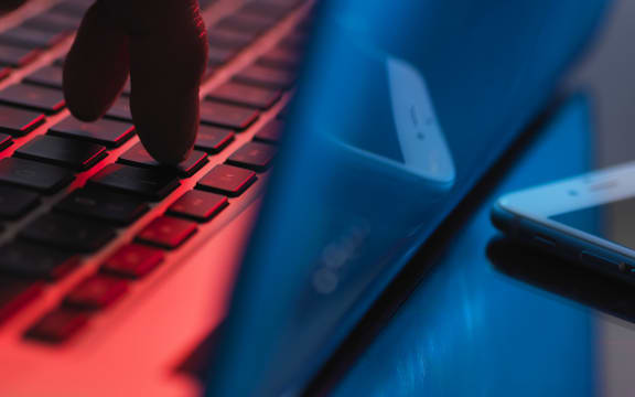A hand enters account details on a laptop (file)