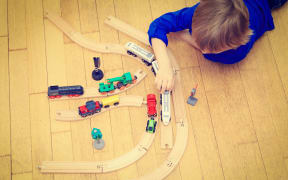 Anonymous boy playing with train generic child's play