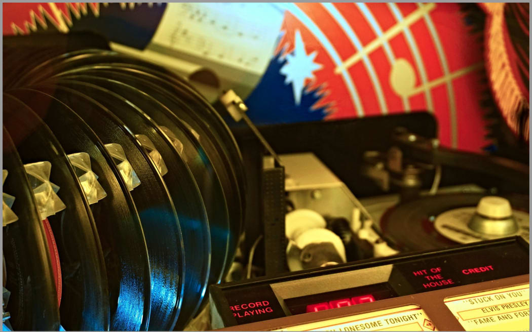 Image of a jukebox, close up to look at the records.
