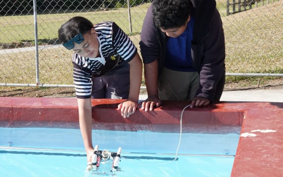 Motatau 12-year-olds Te Maioha Tipene, left, and Zacchaeus Tua test their aquabot in the school pool.