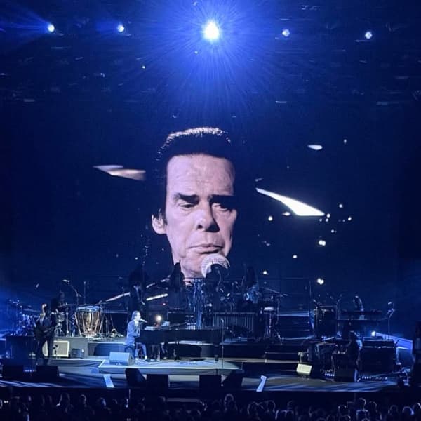 Nick Cave's distinctive was projected on three big screens during the gig.