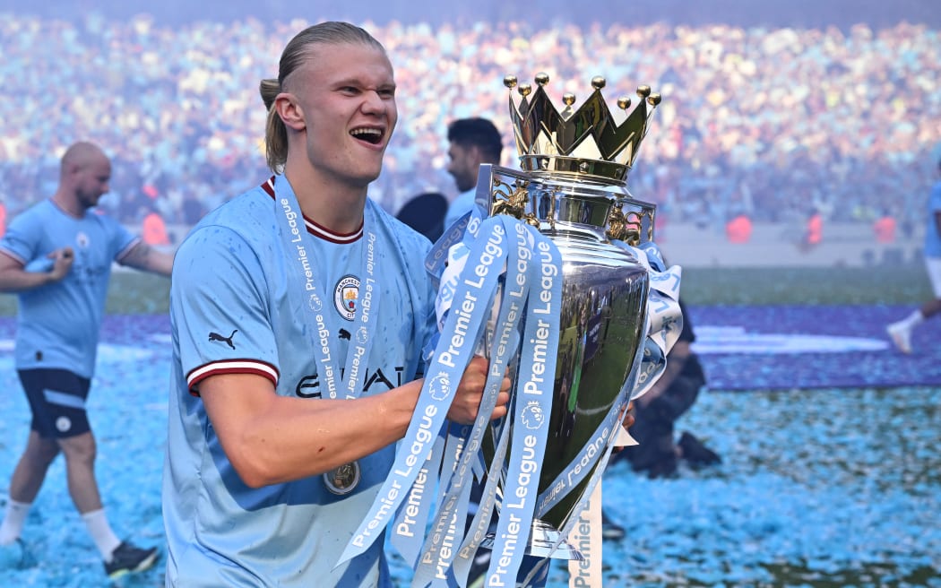 Manchester City's Norwegian striker Erling Haaland poses with the Premier League trophy 2023.