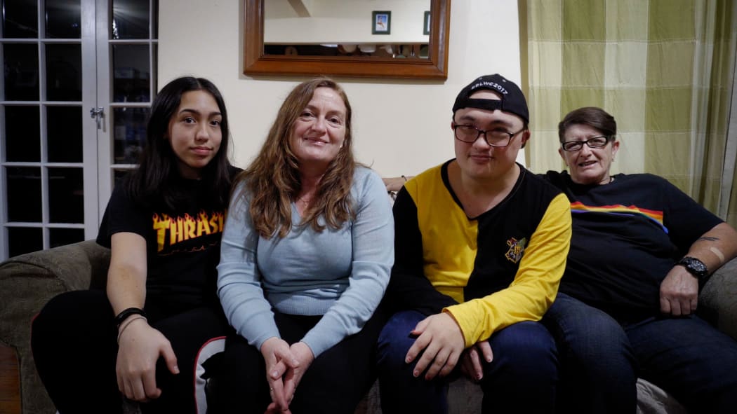 Jesse Coles-Hart sits with his family at home.